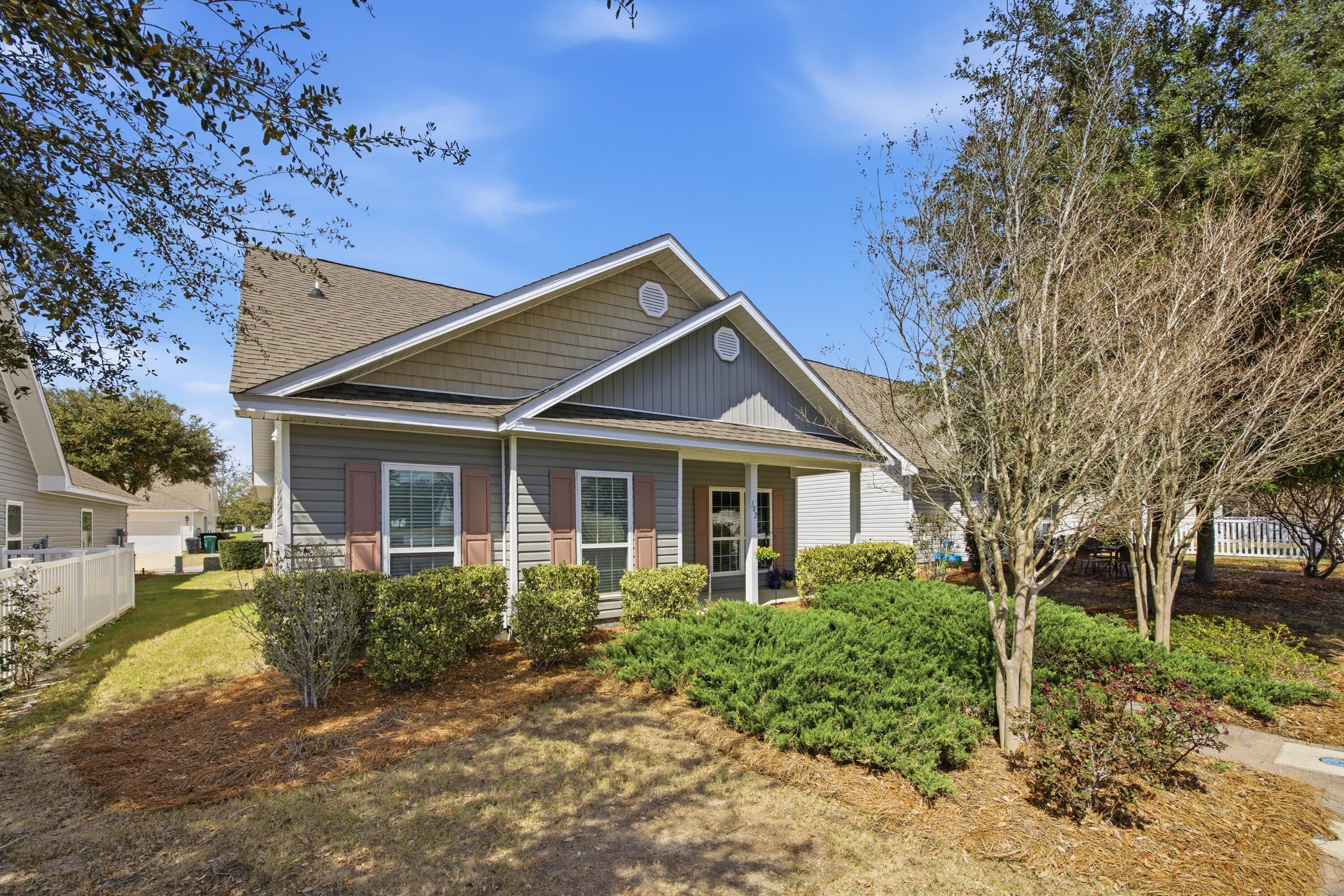102 Cornelia Street Freeport, FL 32439 - Photo 3 of 39 a front view of a house with garden