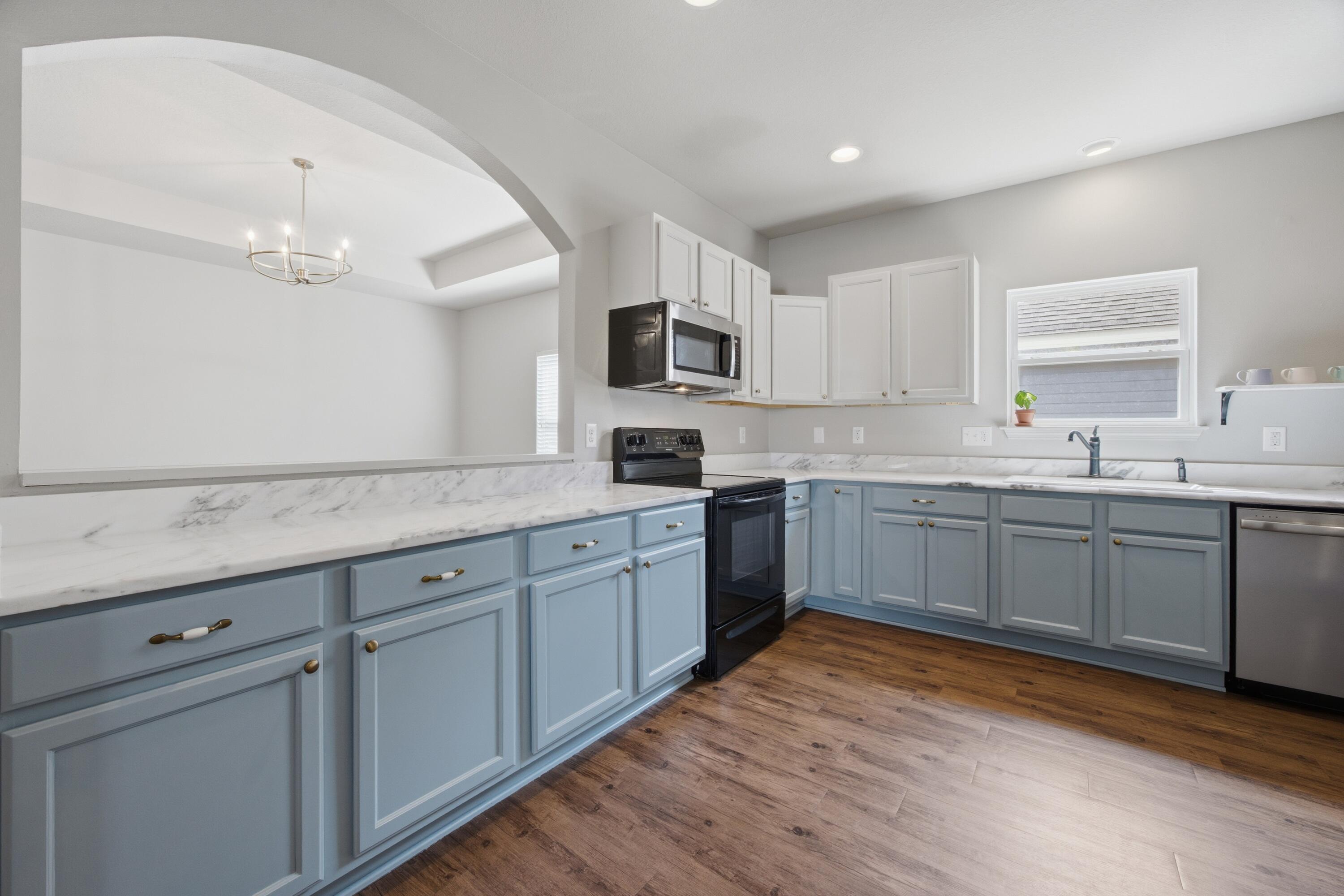 102 Cornelia Street Freeport, FL 32439 - Photo 31 of 39 a kitchen with granite countertop a sink cabinets and stainless steel appliances