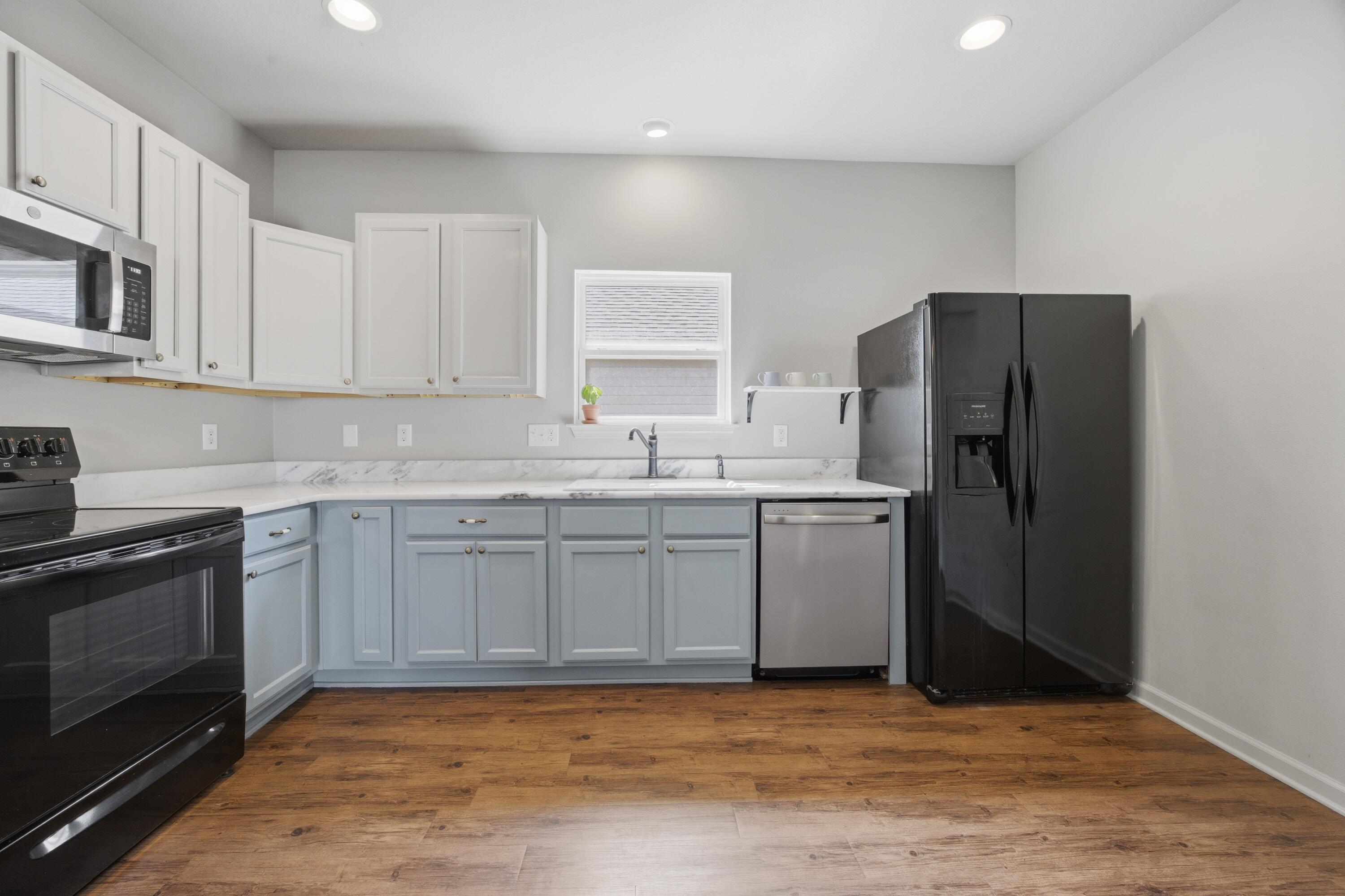 102 Cornelia Street Freeport, FL 32439 - Photo 32 of 39 a kitchen with granite countertop a refrigerator stove and sink