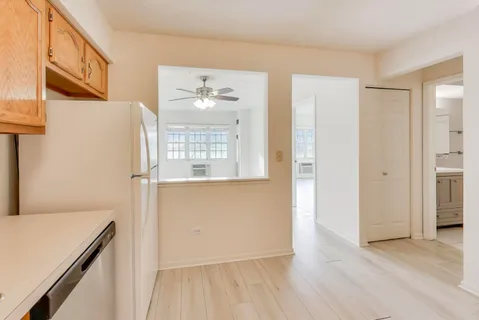 a view of a room with wooden floor and cabinet