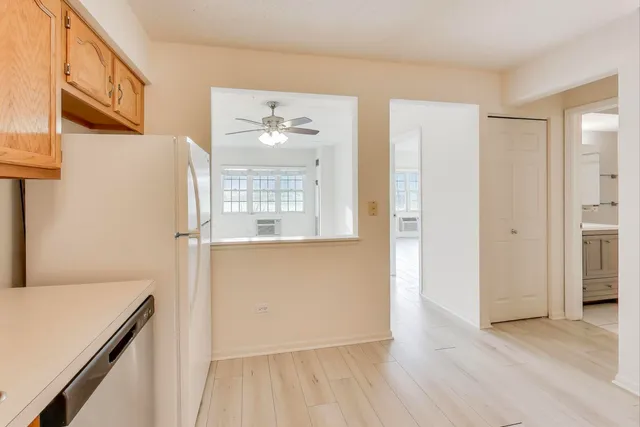 a view of a room with wooden floor and cabinet