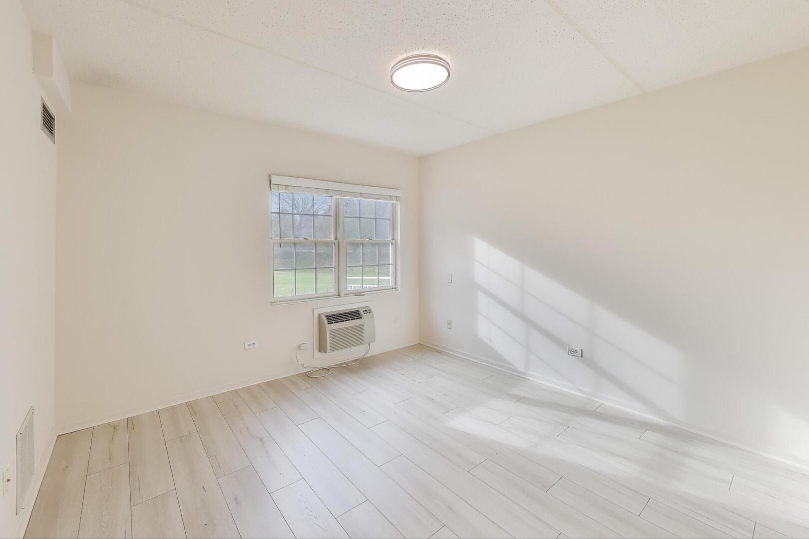 1220 Depot Street, Unit 109 Glenview, IL 60025 - Photo 14 of 35 an empty room with windows