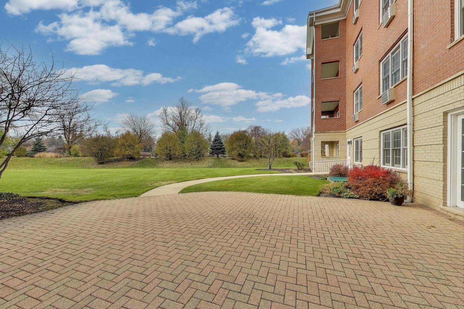 1220 Depot Street, Unit 109 Glenview, IL 60025 - Photo 29 of 35 a view of a building and a yard