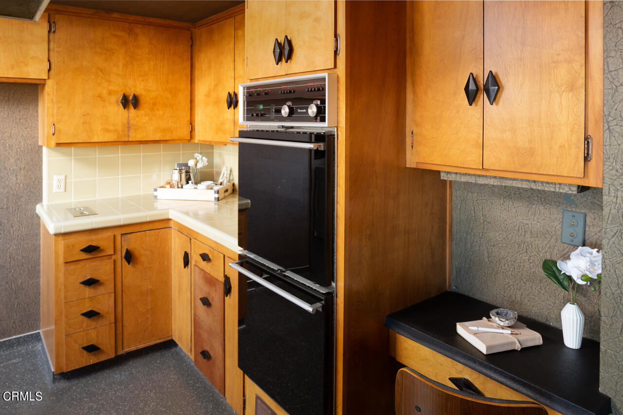 2207 Pinecrest Drive Altadena, CA 91001 - Photo 14 of 43 a kitchen with a refrigerator and a stove top oven