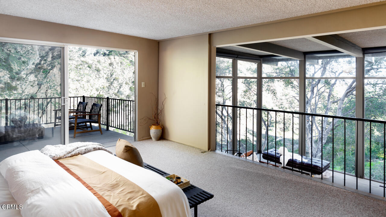 2207 Pinecrest Drive Altadena, CA 91001 - Photo 19 of 43 a bedroom with furniture and large windows