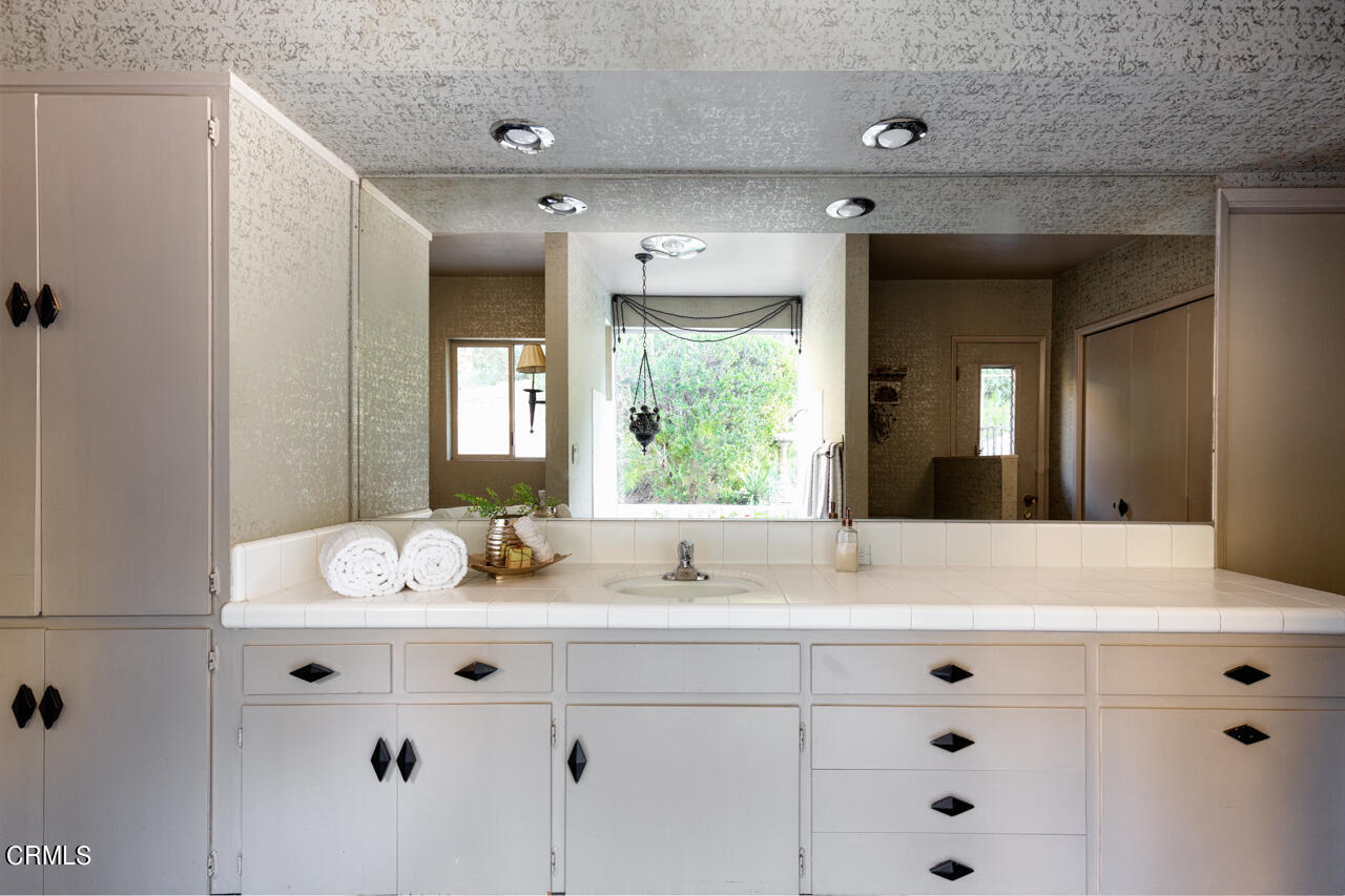 2207 Pinecrest Drive Altadena, CA 91001 - Photo 23 of 43 a bathroom with a granite countertop sink mirror and double