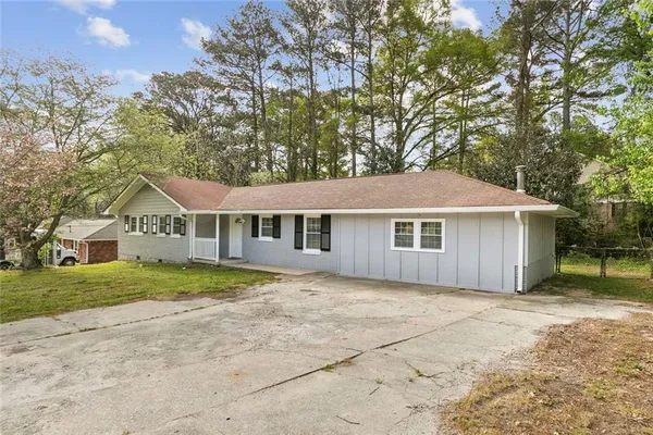 a house that has a tree in front of it