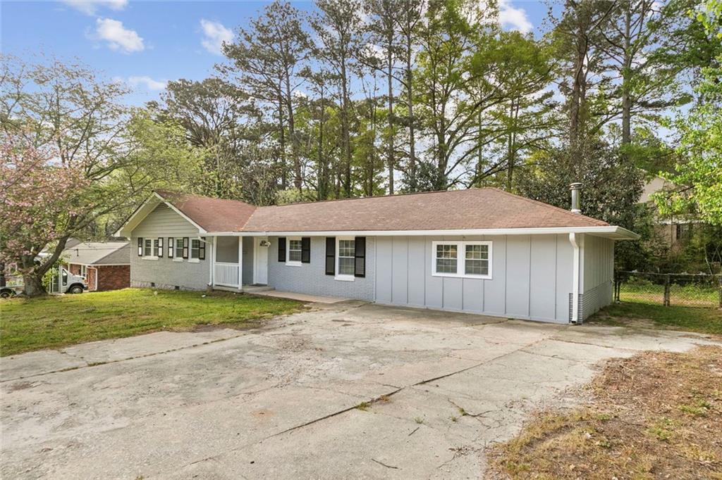 a house that has a tree in front of it