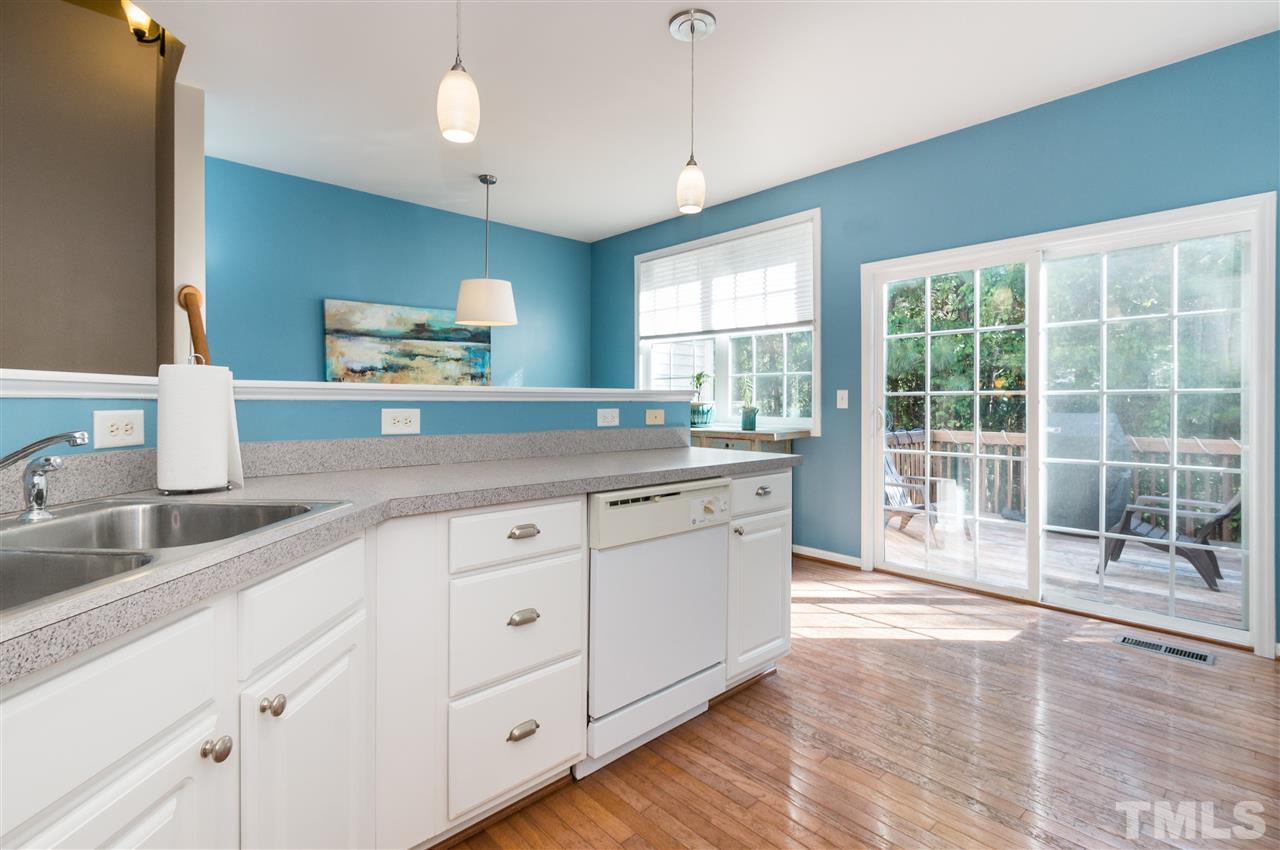5406 Echo Ridge Road Raleigh, NC 27612 - Photo 14 of 25 a kitchen with granite countertop a sink and white cabinets