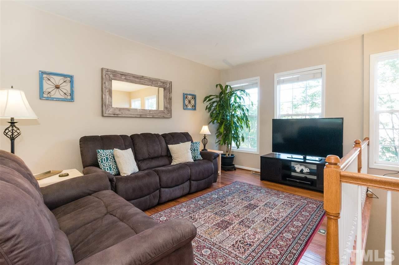5406 Echo Ridge Road Raleigh, NC 27612 - Photo 8 of 25 a living room with furniture and a flat screen tv