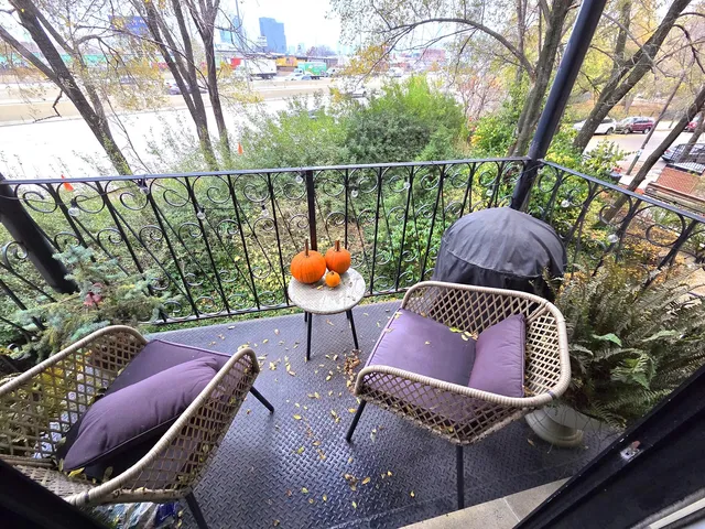 a outdoor sitting area with furniture and wooden floor