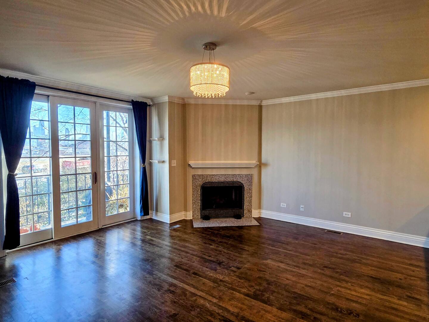 1422 North Noble Street, Unit 2S Chicago, IL 60642 - Photo 2 of 15 an empty room with wooden floor fireplace and windows