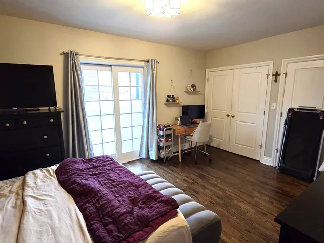 a spacious bedroom with a bed and a window