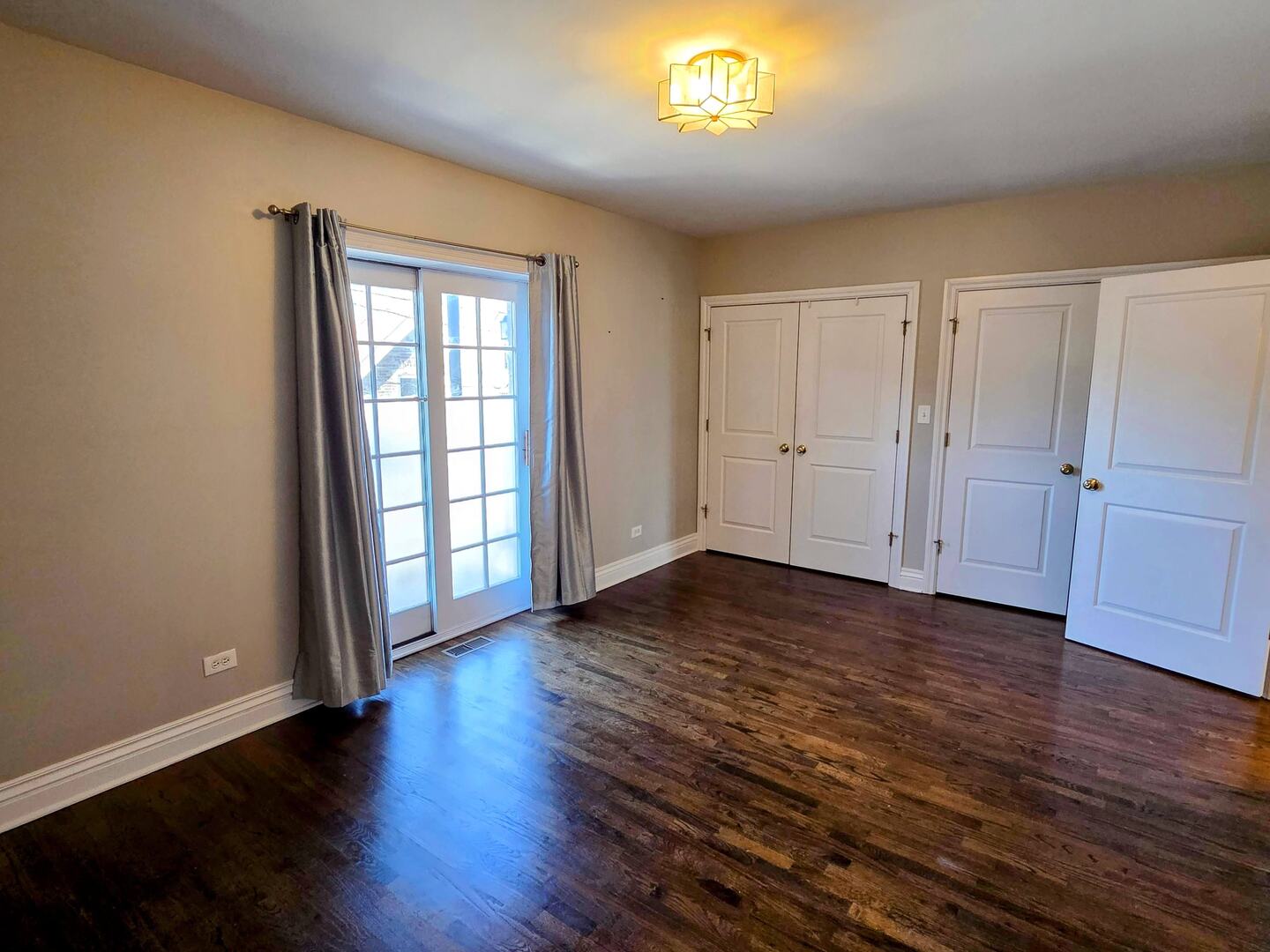 1422 North Noble Street, Unit 2S Chicago, IL 60642 - Photo 8 of 15 an empty room with wooden floor and windows