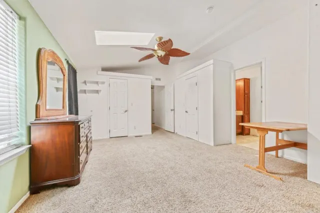 a bathroom with a granite countertop sink and a bathtub