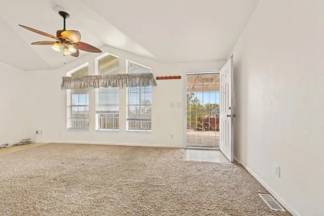 a view of a balcony with floor to ceiling windows with wooden floor