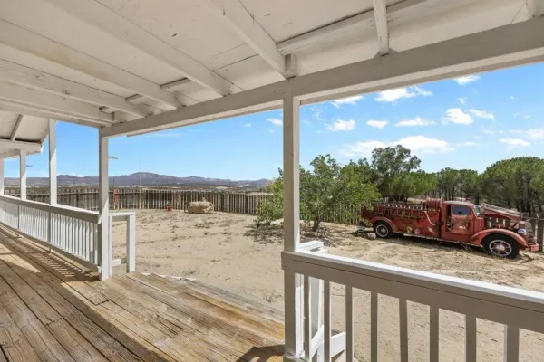 a front view of a house with cars parked
