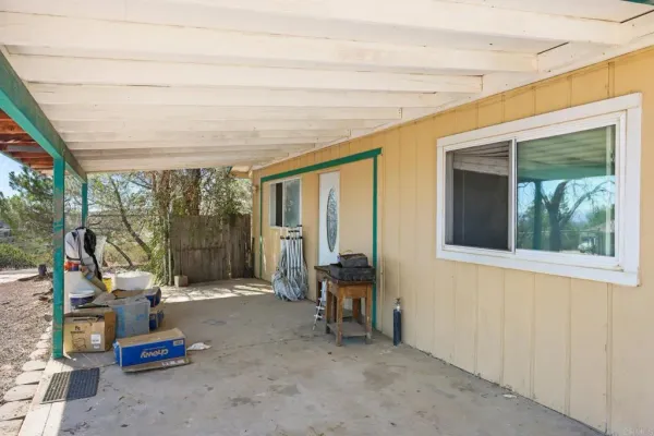 an empty room with a ceiling fan and window