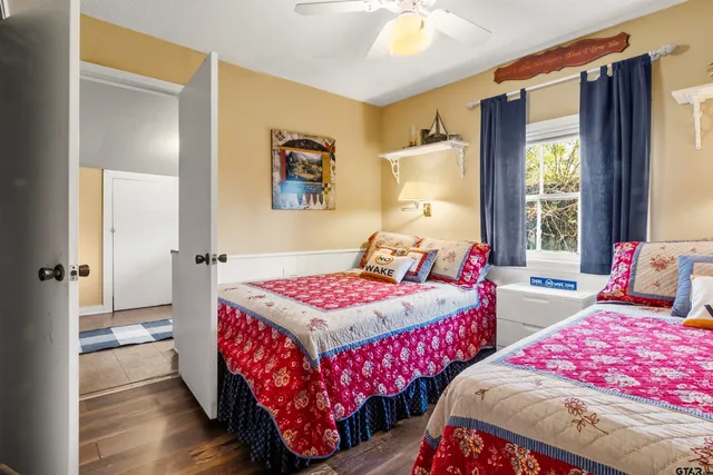 a bedroom with two beds and a window