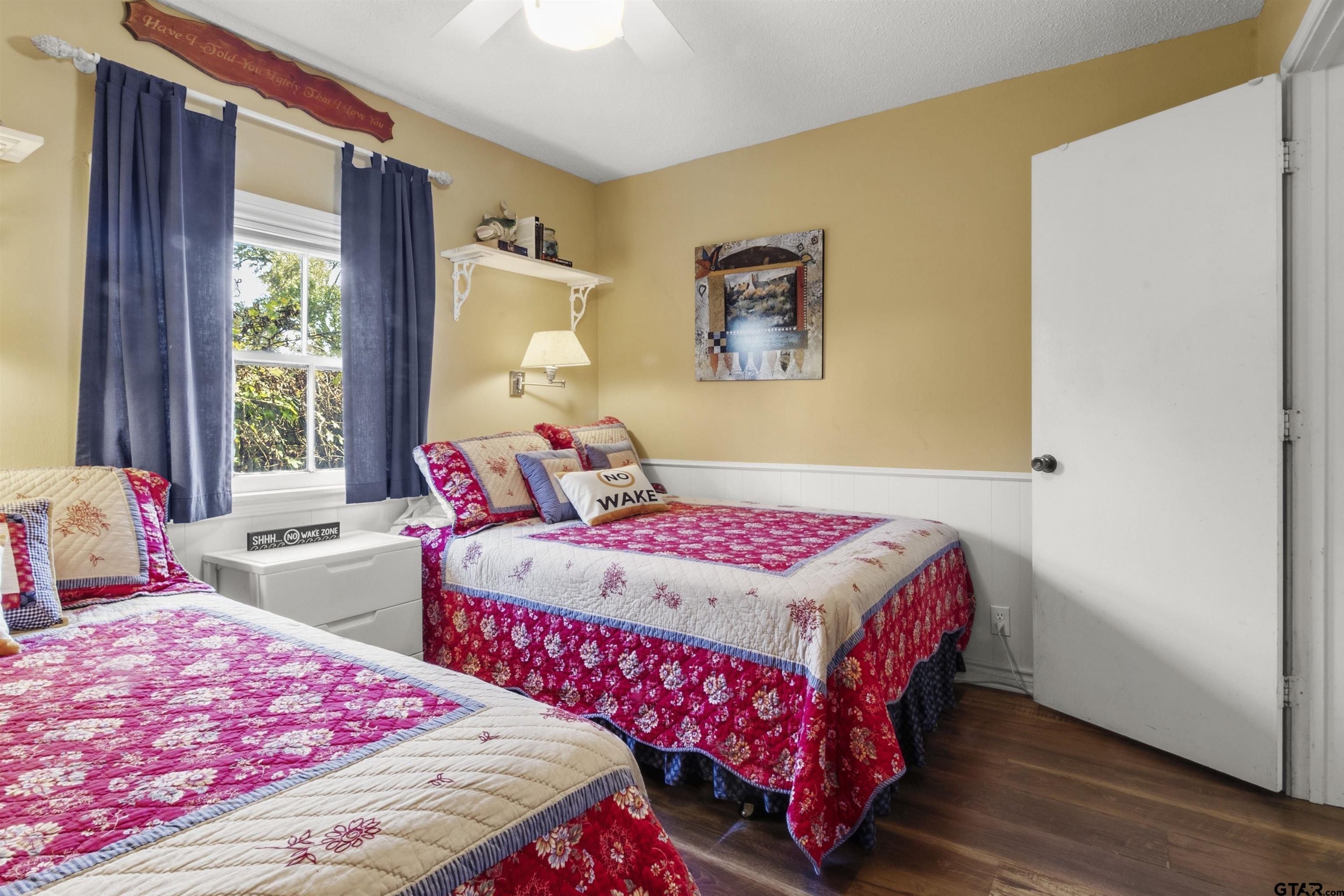 14131 West Peninsula Road Whitehouse, TX 75791 - Photo 17 of 28 a bedroom with two beds and a large window