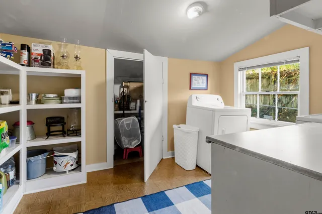 a view of living room with furniture and a book shelf