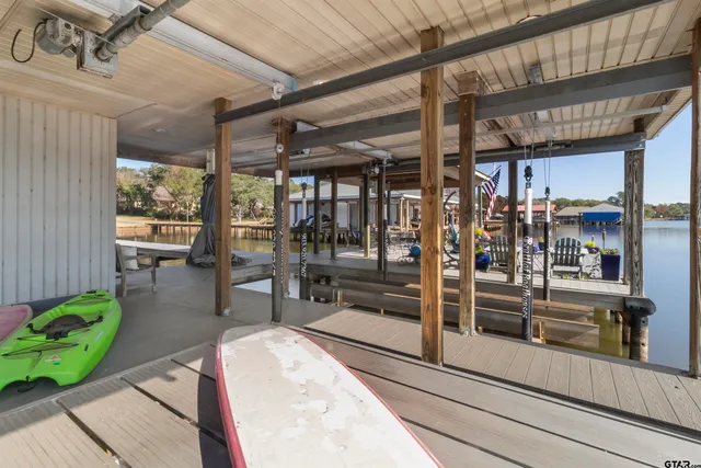 a view of a porch with chairs and potted plants