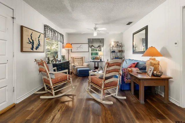 a living room with furniture a rug and a table