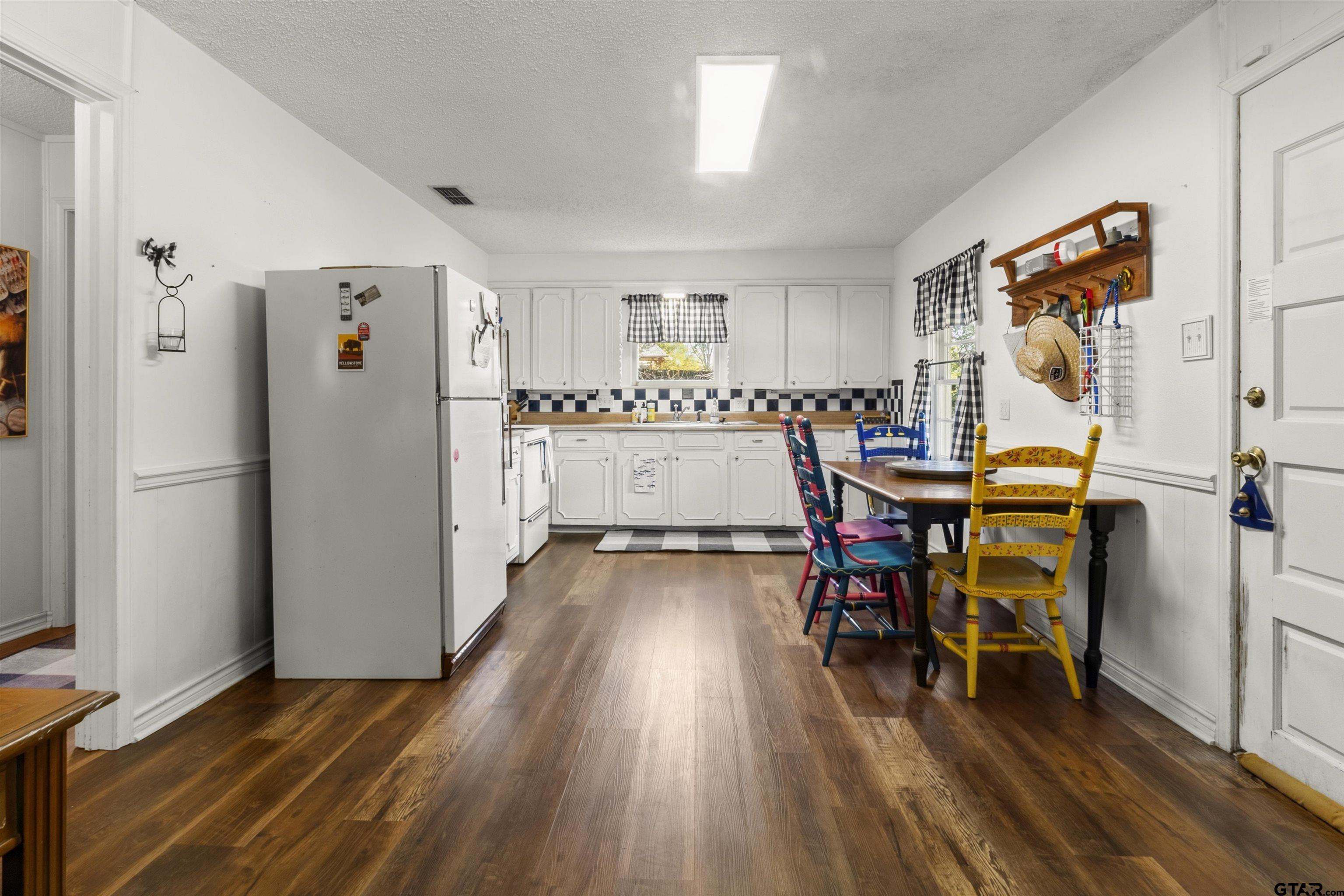 14131 West Peninsula Road Whitehouse, TX 75791 - Photo 9 of 28 a view of a dining room with furniture and wooden floor