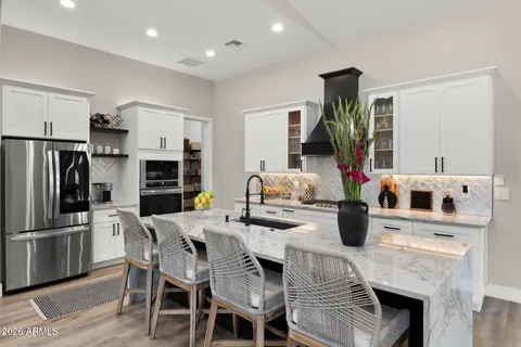 a view of kitchen with refrigerator dining table and chairs