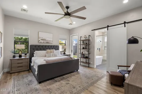 a bed room with a bed and a chair