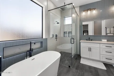 a spacious bathroom with a double vanity sink a toilet and a mirror