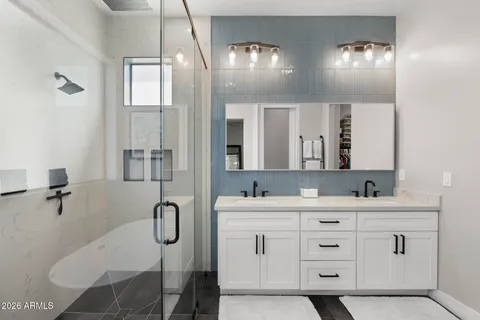 a bathroom with a double vanity sink and mirror