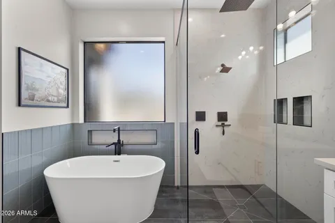 a white bath tub sitting next to a white sink