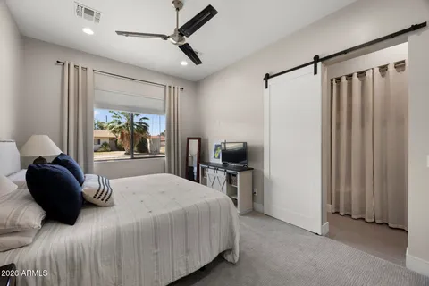 a bedroom with a bed and a television