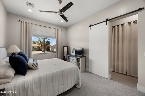 a bedroom with a bed and a television