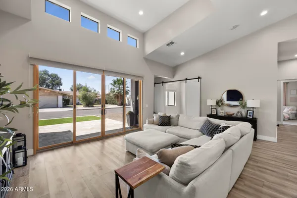 a living room with furniture and a floor to ceiling window