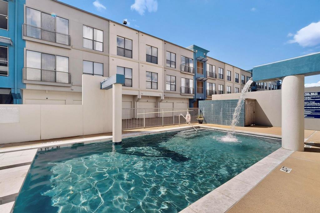 4414 Cedar Springs Road, Unit 318 Dallas, TX 75219 - Photo 34 of 40 Outdoor swimming pool featuring a waterfall element and integrated fountain