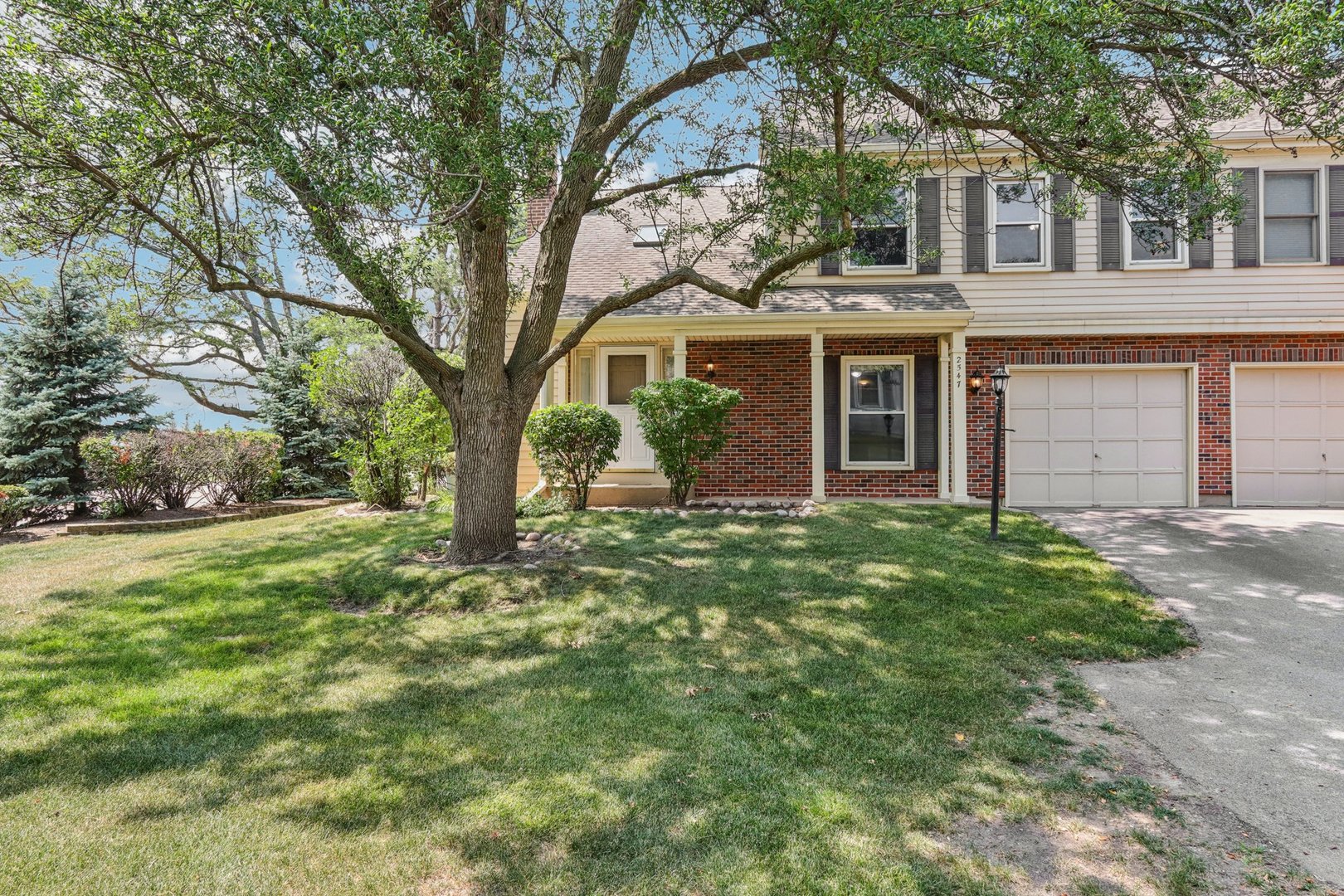 2547 College Hill Circle, Unit 404 Schaumburg, IL 60173 - Photo 1 of 28 front view of a house with a yard