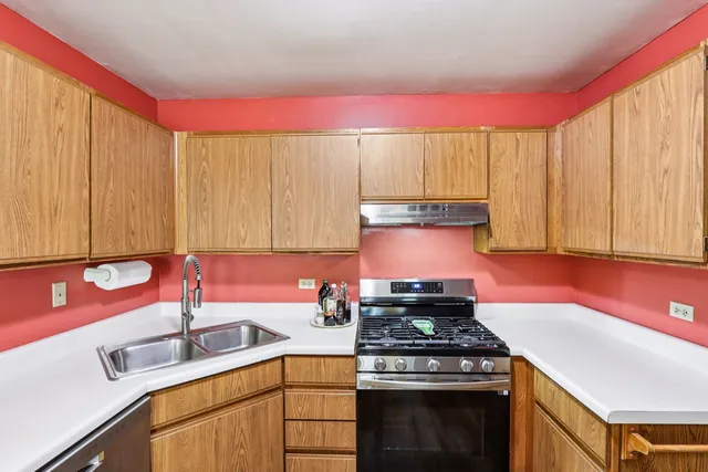 a kitchen with a stove a sink and a cabinets