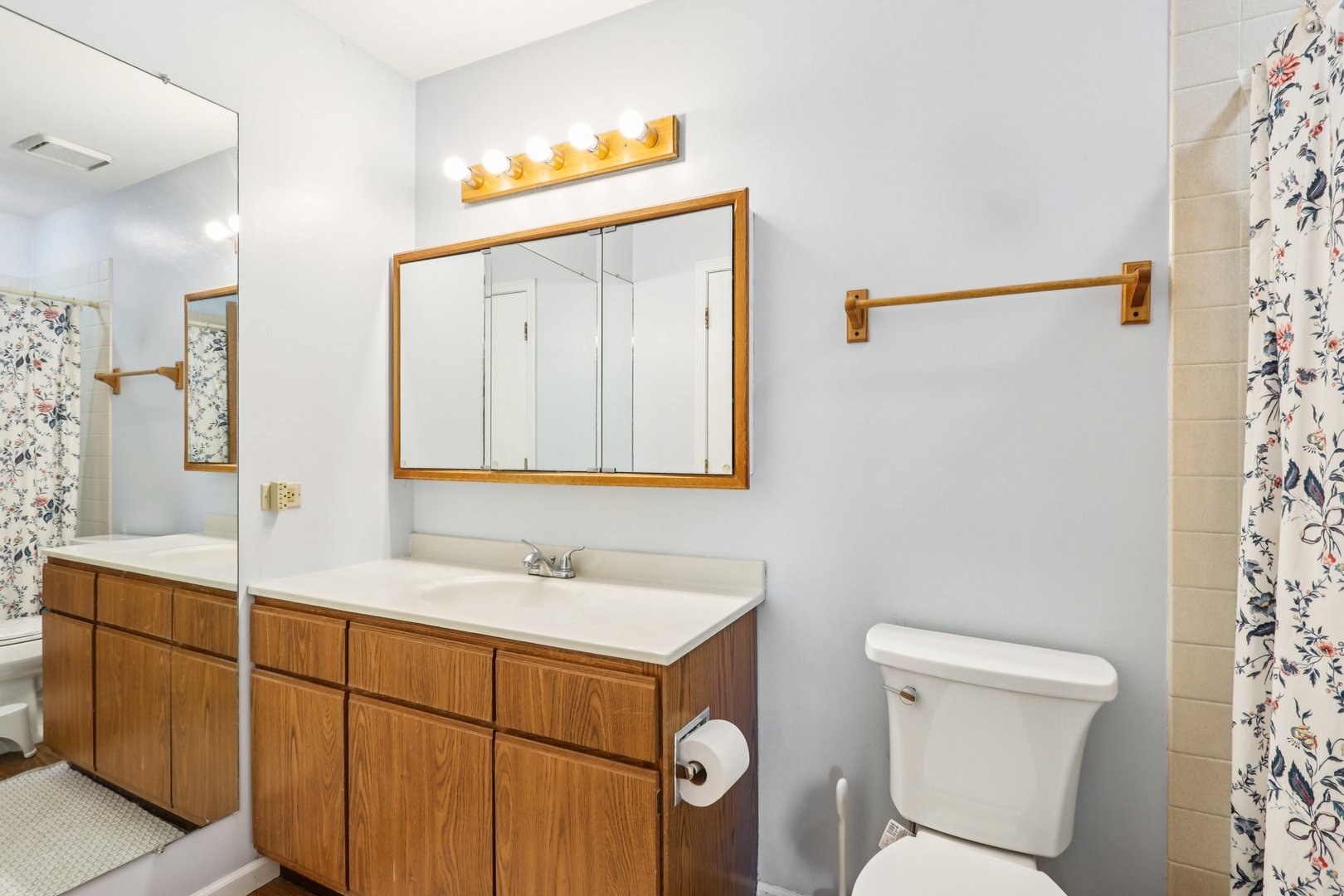 2547 College Hill Circle, Unit 404 Schaumburg, IL 60173 - Photo 19 of 28 a bathroom with a sink mirror vanity and toilet