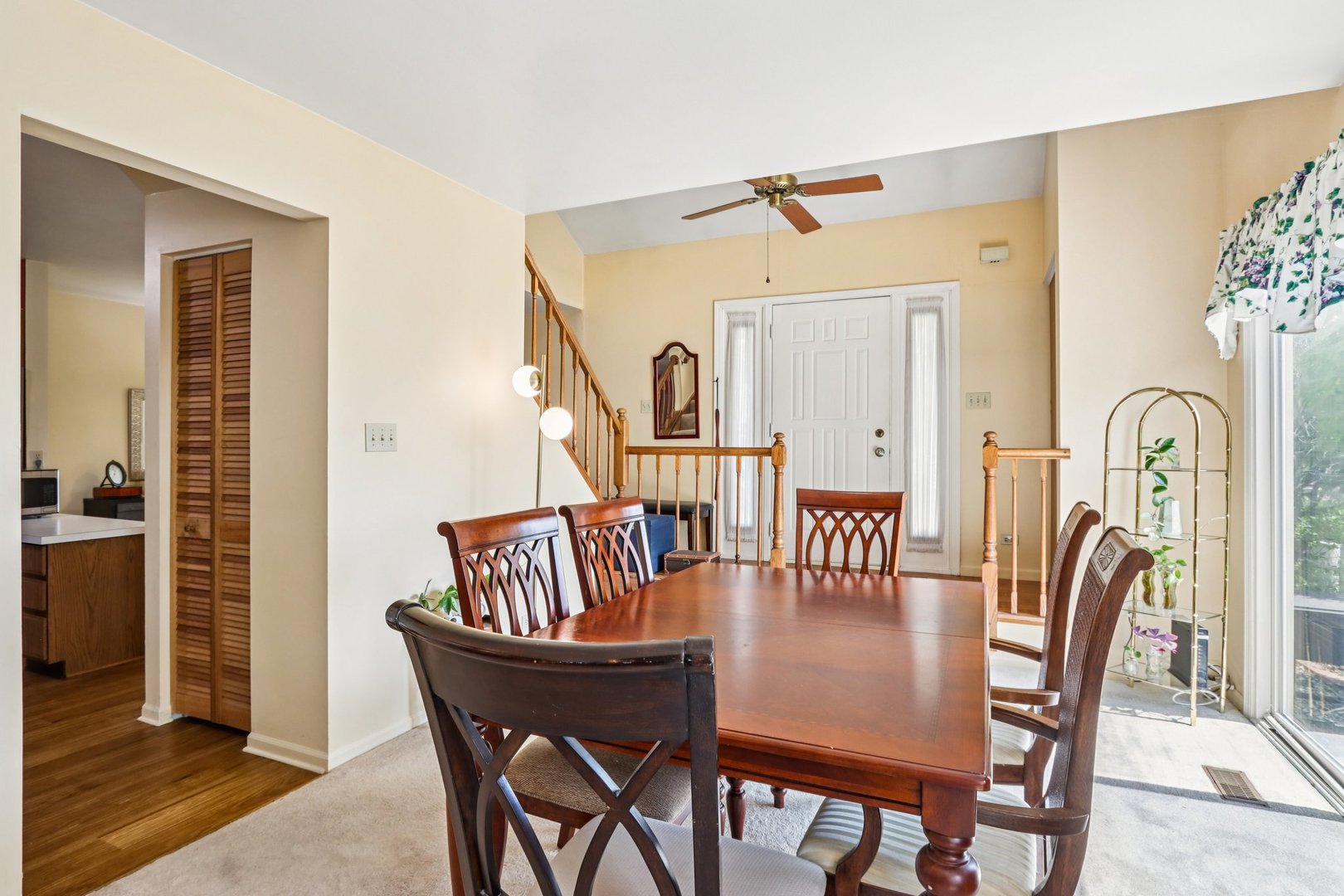 2547 College Hill Circle, Unit 404 Schaumburg, IL 60173 - Photo 3 of 28 a view of a dining room with furniture and wooden floor