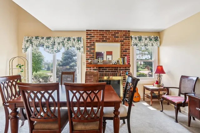 a dining room with furniture entryway and wooden floor