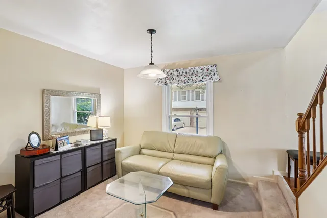 a living room with stainless steel appliances kitchen island granite countertop a dining table and chairs with wooden floor