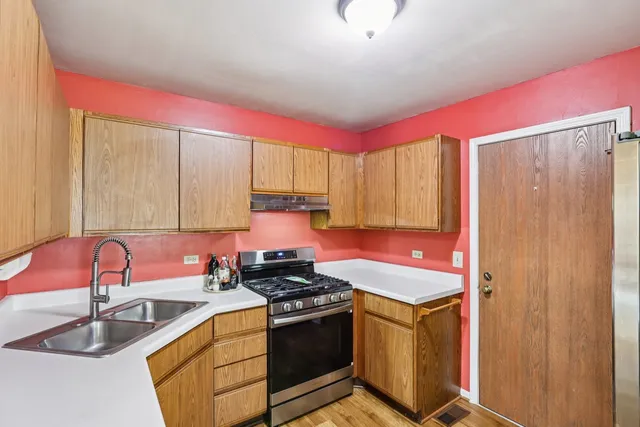 a kitchen with a stove and a sink