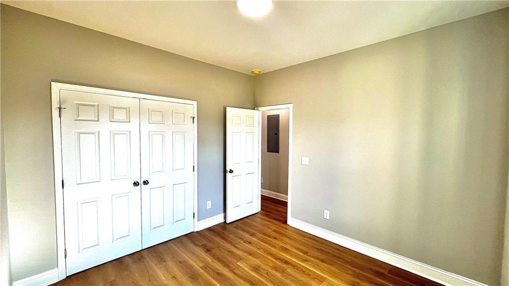 23 S Road Griffin, GA 30224 - Photo 26 of 32 an empty room with wooden floor and a window