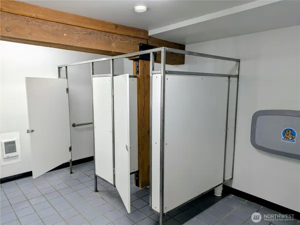 a bathroom with a sink a toilet and mirror
