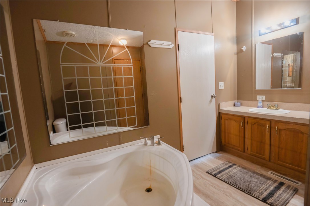 4594 Center Road Andover, OH 44003 - Photo 19 of 39 Bathroom with vanity and a bath