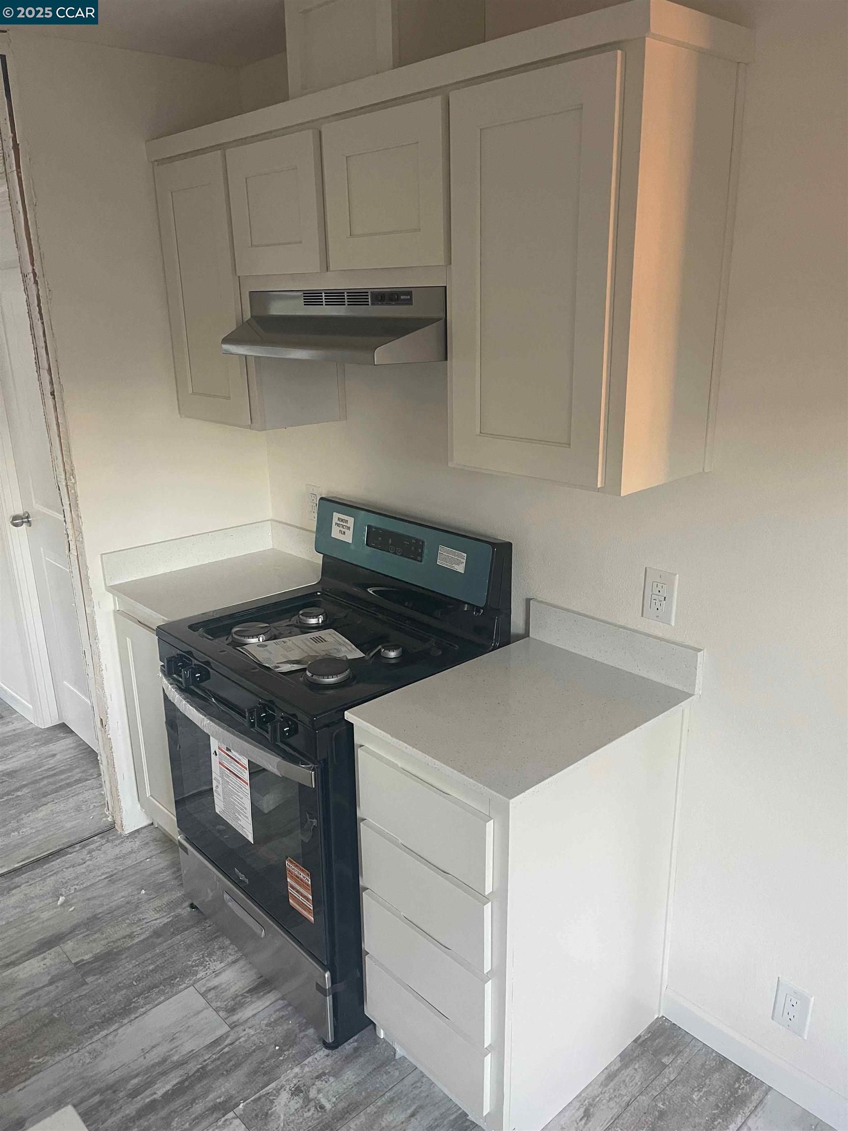 3777 Willow Pass Road, Unit 85 Bay Point, CA 94565 - Photo 5 of 7 a kitchen with granite countertop a stove and a sink