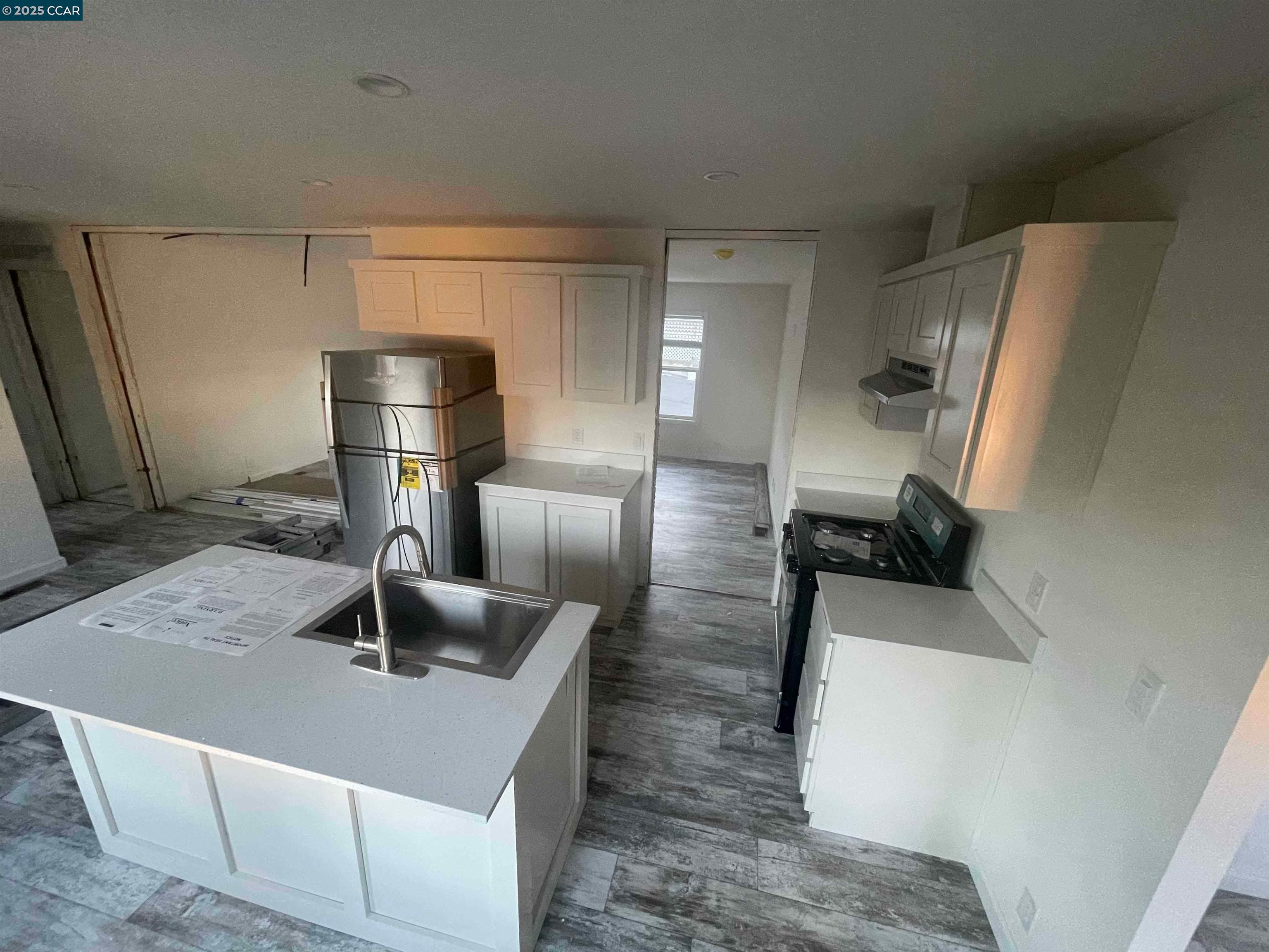 3777 Willow Pass Road, Unit 85 Bay Point, CA 94565 - Photo 7 of 7 a kitchen with a sink a refrigerator and washer