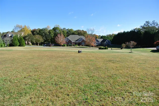 a view of a field with an trees in the background